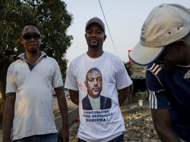 Supporters of President Pierre Nkurunziza, one wearing a t-shirt depicting the president, look on following the announcement of preliminary results in Burundi's presidential elections on July 24, 2015. Nkurunziza won an outright majority in the controversial polls with 69.41% of the vote. (AFP Photo) Supporters of President Pierre Nkurunziza, one wearing a t-shirt depicting the president, look on following the announcement of preliminary results in Burundi's presidential elections on July 24, 2015. Nkurunziza won an outright majority in the controversial polls with 69.41% of the vote. (AFP Photo)