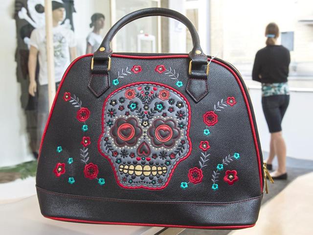 Skull motiffs adorn a handbag at the Buy now, die later! exhibition in the Sepuchral Store. (AP Photo/Jens Meyer) Skull motiffs adorn a handbag at the Buy now, die later! exhibition in the Sepuchral Store. (AP Photo/Jens Meyer)