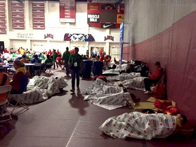 Special Olympics competitors sleep on the gymnasium floor at Loyola Marymount University in Los Angeles early on Wednesday, July 22, 2015. Special Olympics spokesman Rich Perelman says 1,500 athletes and coaches spent the night there after flights and buses arrived late on Tuesday. The Red Cross provided blankets and water for the athletes from Norway, Mexico, Venezuela, Kenya, and the Cayman Islands. (AP Photo)