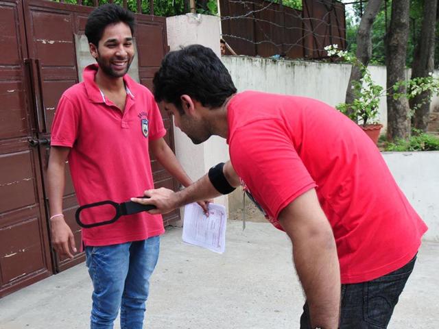 A candidate being frisked at an AIPMT retest centre in Chandigarh on Saturday. Ravi Kumar/HT
