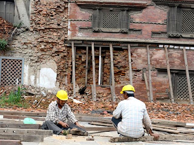 Construction workers in Basantapur Durbar Square renovate a heritage site in quake-hit Kathmandu. (AFP Photo)
