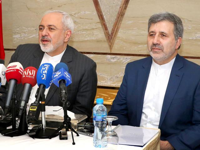 Iran's foreign minister Mohammad Javad Zarif (L) attends a press conference with Iranian ambassador to Kuwait Ali Reza Enayati in Kuwait City. (AFP Photo)