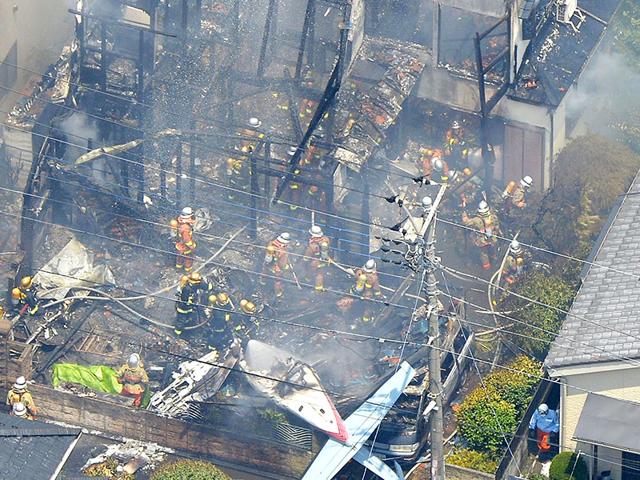 An aerial view shows debris of a crashed light plane (bottom C) and burning houses are seen after the plane went down in a residential area and burst into flames, in Chofu, outskirt of Tokyo. (Reuters)