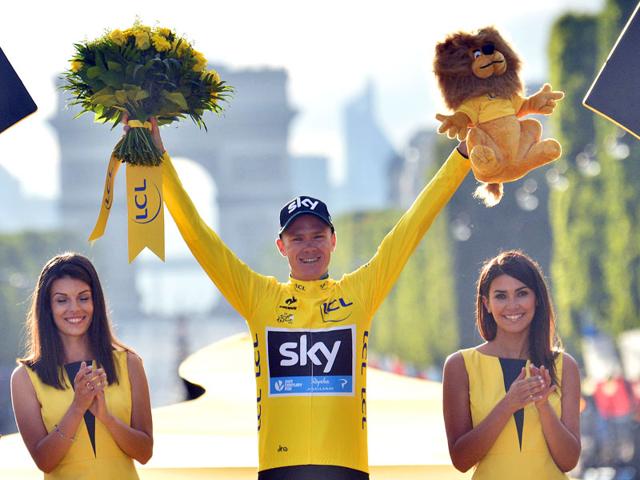 Britain's Christopher 'Chris' Froome, center, celebrates as he stands on the podium after winning the 2015 Tour de France cycling race in Paris, France, on July 26, 2015. (AP Photo)