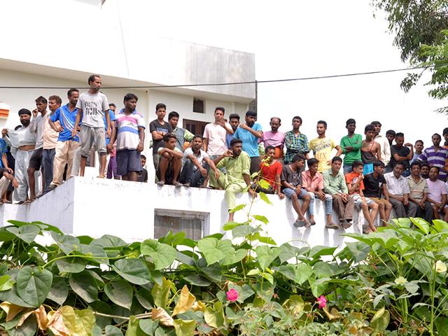 Residents watch as security forces battle armed attackers at the police station in Dinanagar town, in the Gurdaspur district of Punjab. (AFP Photo)