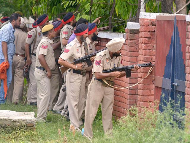 Punjab police personnel take position during an encounter with armed attackers at the police station in Dinanagar town in Gurdaspur district. (AFP Photo) Punjab police personnel take position during an encounter with armed attackers at the police station in Dinanagar town in Gurdaspur district. (AFP Photo)
