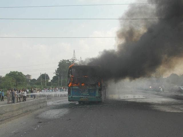 Firefighters in action after a Punjab Roadways bus caught fire in Jalandhar on Tuesday. HT Photo Firefighters in action after a Punjab Roadways bus caught fire in Jalandhar on Tuesday. HT Photo