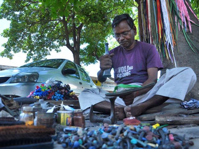 Ram Badsish mending shoes at Sector 27 in Chandigarh on Sunday. Karun Sharma/HT Ram Badsish mending shoes at Sector 27 in Chandigarh on Sunday. Karun Sharma/HT