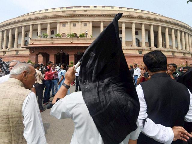 Congress leaders carry black flags during a protest against suspension of 25 party members in New Delhi on Tuesday. (PTI Photo)