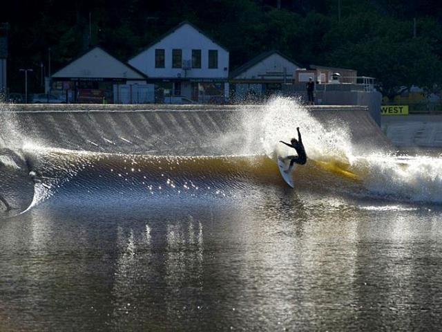 A surfer experiences a 300m long and 110m wide artificial lagoon known as Surf Snowdonia in the village of Dolgarrog in north Wales. (AFP Photo)