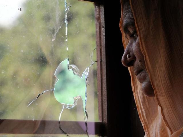 A villager standing near broken glass during heavy shelling from Pakistan side at India-Pakistan International border in Jammu at Pargwal sector, Akhnoor, on Tuesdaya. One civillian died and one BSf soldier injured in firing.(Photo by Nitin Kanotra / Hindustan Times)