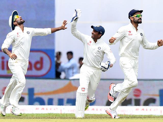 Dhawan (L), Saha (C) and Kohli celebrate the dismissal of Kaushal Silva. (AFP Photo)