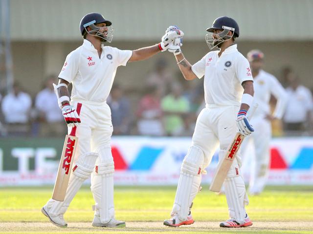 India's Virat Kohli (R) and Shikar Dhawan cheer each other as they complete their hundred runs partnership during the first cricket Test match between India and Sri Lanka in Galle on Wednesday. (AP Photo) India's Virat Kohli (R) and Shikar Dhawan cheer each other as they complete their hundred runs partnership during the first cricket Test match between India and Sri Lanka in Galle on Wednesday. (AP Photo)