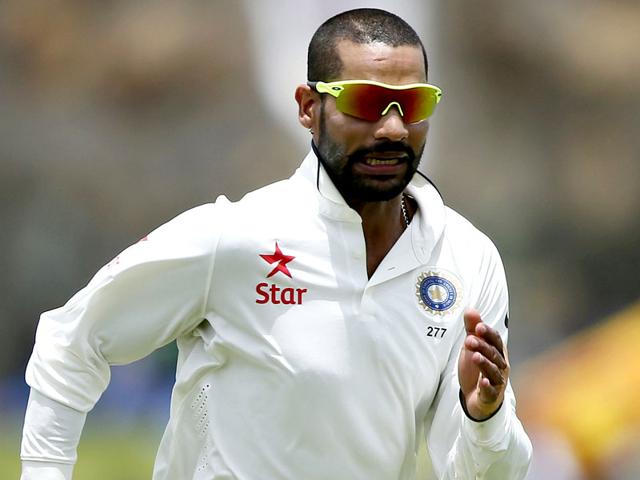 Shikhar Dhawan's hat flies off as he runs after the ball to stop a boundary hit by Mathews. (Reuters Photo)
