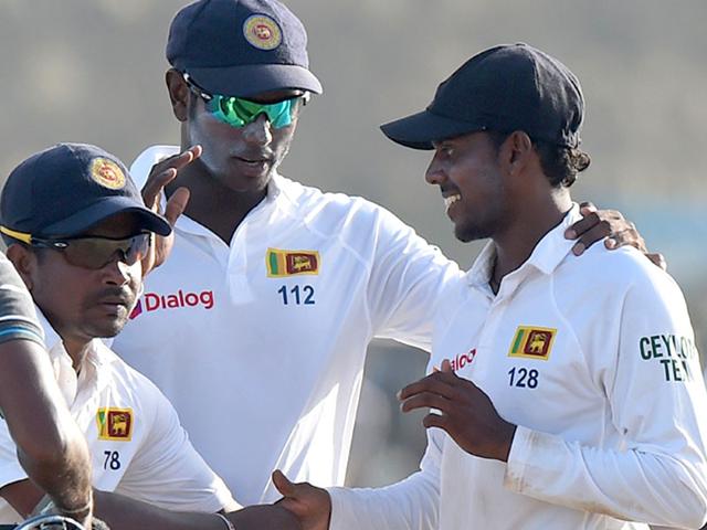 Sri Lanka cricket team captain Angelo Mathews (C) and teammates Tharindu Kaushal (R) and Rangana Herath (2L) leave the pitch at the end of India's first innings during the second day of the opening Test match between Sri Lanka and India at the Galle International Cricket Stadium in Galle . AFP PHOTO/ Ishara S. KODIKARA