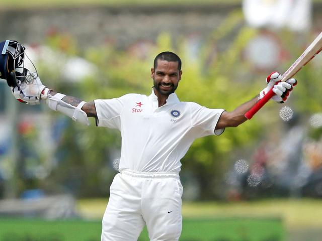 India's Shikhar Dhawan celebrates his century during the second day of their first test cricket match against Sri Lanka in Galle,. REUTERS/Dinuka Liyanawatte