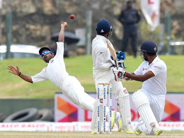 Rahane, left, misses a catch off the batting of Lahiru Thirimanne, right, as Wriddhiman Saha looks on. (AFP Photo) Rahane, left, misses a catch off the batting of Lahiru Thirimanne, right, as Wriddhiman Saha looks on. (AFP Photo)