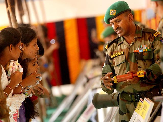 An Indian Army personnel interacts with students at an exhibition of defence equipments, at Ghatkopar on Independence Day. (Arijit Sen/HT photo)