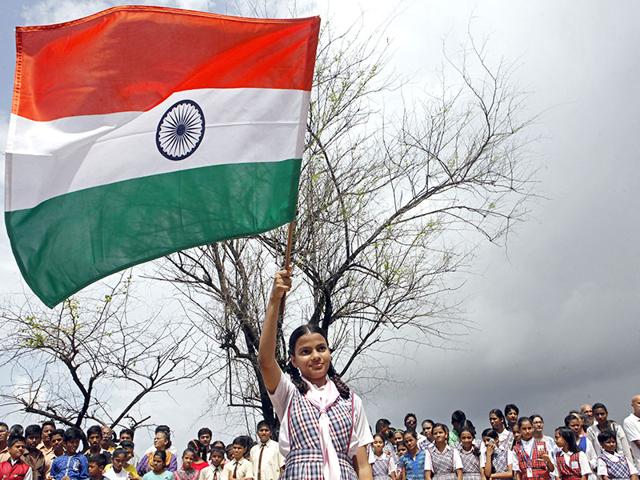 A school student waves the tricolour during Independence Day celebrations, at Bandra's Carter Road in Mumbai.(Pratham Gokhale/HT photo)