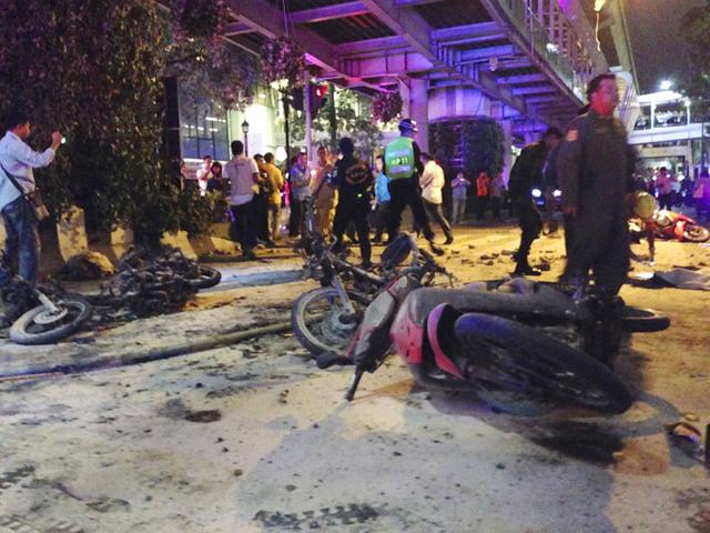 Motorcycles are strewn after an explosion hit in Bangkok on Monday evening. A large explosion rocked a central Bangkok intersection during the evening rush hour, killing a number of people and injuring others, police said. (AP Photo/Jerry Harmer) Motorcycles are strewn after an explosion hit in Bangkok on Monday evening. A large explosion rocked a central Bangkok intersection during the evening rush hour, killing a number of people and injuring others, police said. (AP Photo/Jerry Harmer)
