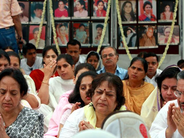 On the 13th anniversary of the Uphaar fire accident on June 13, 2010, 74 years old Hansraj who lost five family members grieves in front of family pics during a prayer meeting at the Uphaar Memorial in front of Uphaar Cinema. (HT file photo/Vipin Kumar)