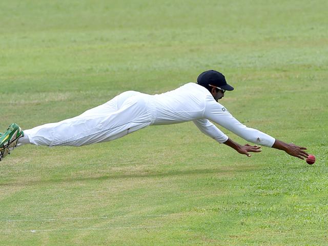 Sri Lanka's Jehan Mubarak dives as he unsuccessfully attempts to stop the ball. (AFP Photo)