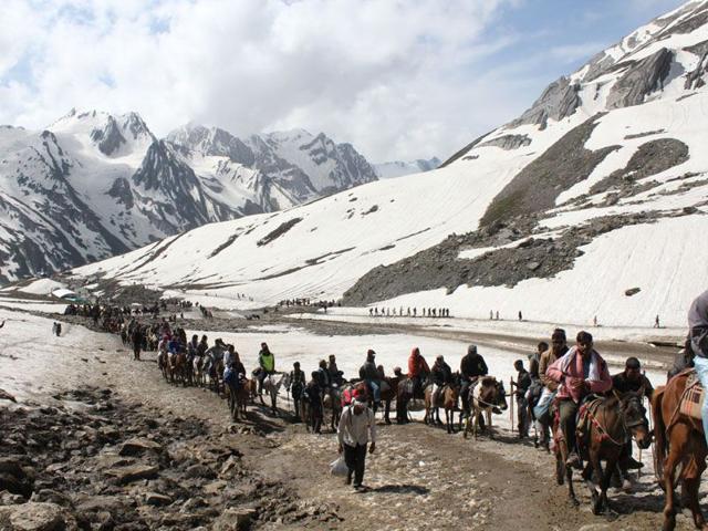 Pilgrims on way to Amarnath Yatra on their mules against backdrop of the Himalayas. Keshav Singh/HT