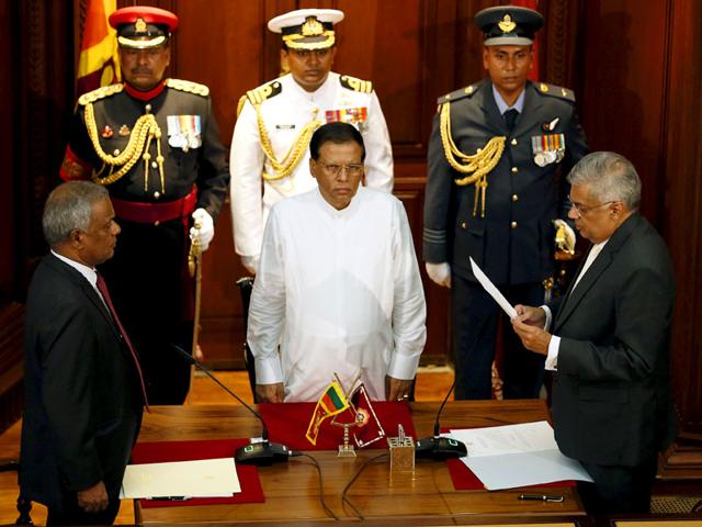 Ranil Wickremesinghe (R), leader of the United National Party, reads his oath of office next to Sri Lanka's President Maithripala Sirisena as he is sworn in as country's new Prime Minister in Colombo. (Reuters) Ranil Wickremesinghe (R), leader of the United National Party, reads his oath of office next to Sri Lanka's President Maithripala Sirisena as he is sworn in as country's new Prime Minister in Colombo. (Reuters)