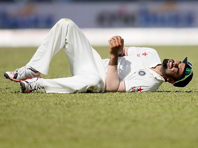 Virat Kohli reacts after being injured during the third day of their second test cricket match against Sri Lanka in Colombo. Reuters/Dinuka Liyanawatte