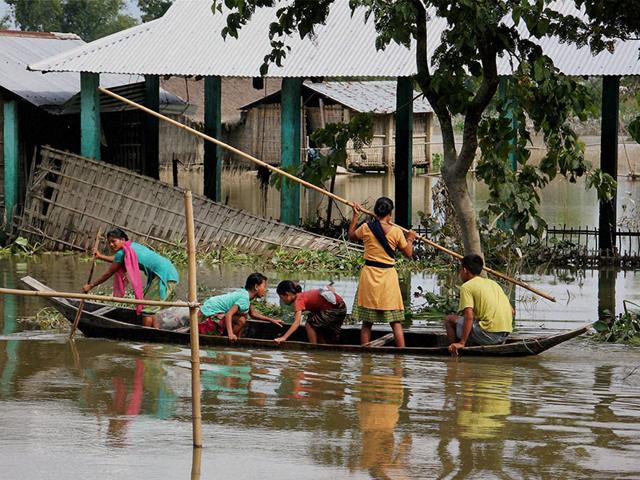 People are rescued from flood affected areas to safer places at Teok in Jorhat district of Assam. (PTI Photo)