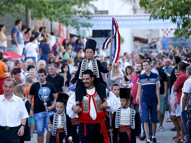 The winner of the Children's Alka competition, Alkar Vito (centre), celebrates in Croatia. (Reuters)