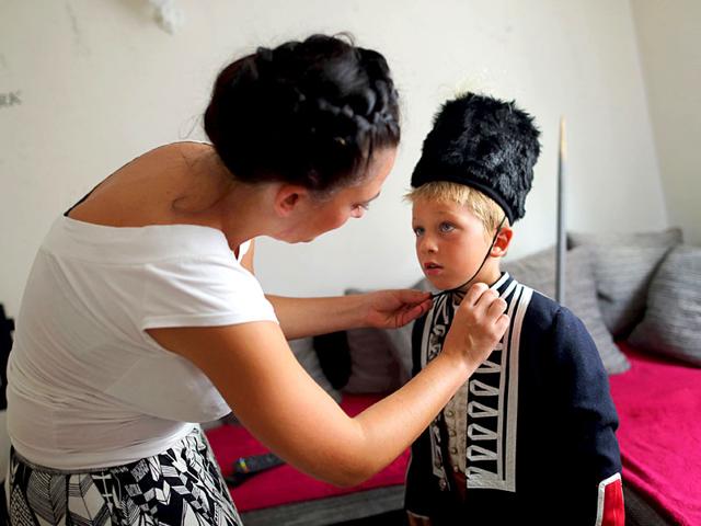 Alkar Vito's mother dresses him in traditional clothes. The tournament is named after the ring, Alka, which children have to hit with their spears. (Reuters)