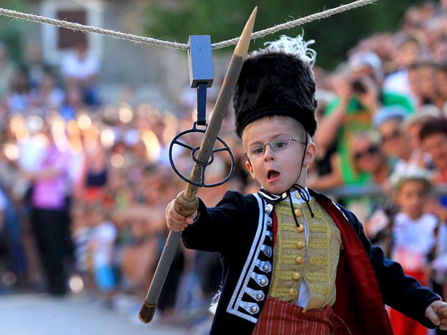 A child runs during the Children's Alka competition on August 23, 2015. The event commemorates Croatia's victory over the Ottomans. (Reuters)