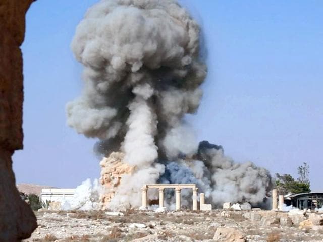 This undated photo released on August 25 shows smoke from the detonation of the 2,000-year-old temple of Baalshamin in Syria's ancient caravan city of Palmyra. (Islamic State social media account via AP) This undated photo released on August 25 shows smoke from the detonation of the 2,000-year-old temple of Baalshamin in Syria's ancient caravan city of Palmyra. (Islamic State social media account via AP)