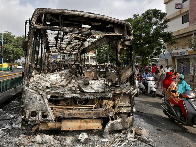 The wreckage of a bus that was burnt in the clashes between the police and protesters in Ahmedabad, India, August 26, 2015. India deployed paramilitary forces and imposed a curfew in the western state of Gujarat on Wednesday after violence broke out at a protest led by the Patel community to demand more government jobs and college places. (REUTERS) The wreckage of a bus that was burnt in the clashes between the police and protesters in Ahmedabad, India, August 26, 2015. India deployed paramilitary forces and imposed a curfew in the western state of Gujarat on Wednesday after violence broke out at a protest led by the Patel community to demand more government jobs and college places. (REUTERS)