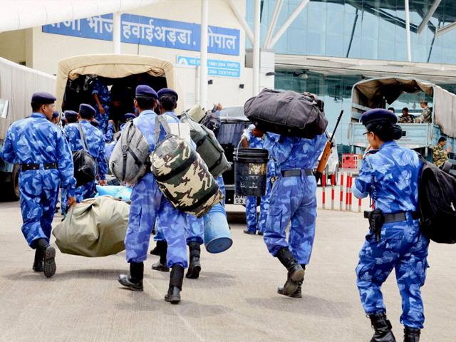 The Rapid Action Force (RAF) personnel arrive in a special Indian Army plane to leave for Gujarat, at Raja Bhoj airport in Bhopal. Defence forces were called in as the Patel community's agitation intensified and spurred violence in several cities of the state. (PTI Photo)