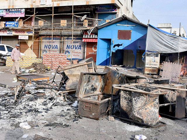 Furniture from a police post was set ablaze by supporters of Hardik Patel, convener of the Patidar Anamat Andolan Samiti, after his detention in Surat on Wednesday. (PTI Photo)