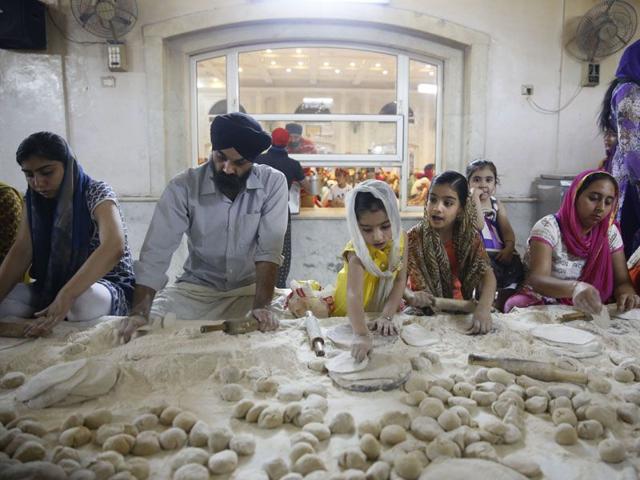 Service being of utmost importance to gurdwaras the devotees make Indian bread (aata) as they prepare langar at the Bangla Sahib Gurdwara in New Delhi. (AP Photo/Manish Swarup) Service being of utmost importance to gurdwaras the devotees make Indian bread (aata) as they prepare langar at the Bangla Sahib Gurdwara in New Delhi. (AP Photo/Manish Swarup)
