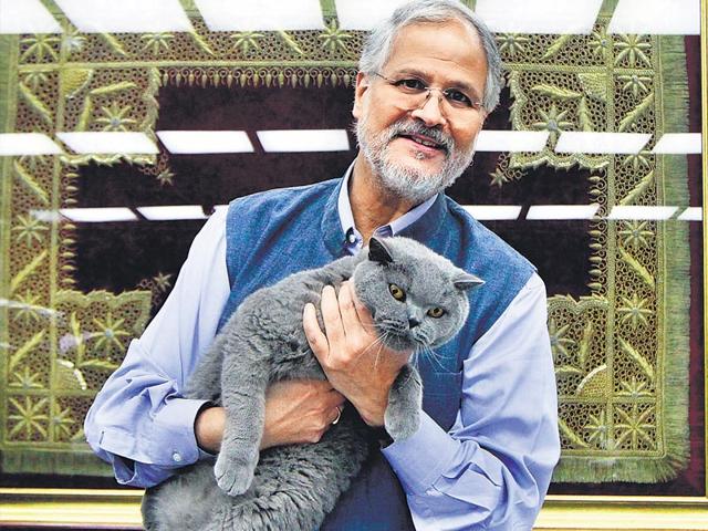 Lieutenant-Governor Najeeb Jung with his cat Munna at Raj Niwas. Jung, who spent a considerable period of his life in Daryaganj, recalls riding through Old Delhi’s lanes on his motorcycle, drinking water off the tap and playing football with his milkman. Behind Jung is a masnad (carpet) given to his family by the Mughals (Sanjeev Verma/HT Photo) Lieutenant-Governor Najeeb Jung with his cat Munna at Raj Niwas. Jung, who spent a considerable period of his life in Daryaganj, recalls riding through Old Delhi’s lanes on his motorcycle, drinking water off the tap and playing football with his milkman. Behind Jung is a masnad (carpet) given to his family by the Mughals (Sanjeev Verma/HT Photo)
