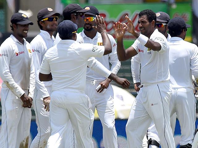 Sri Lanka's Dhammika Prasad, centre, celebrates the dismissal of Sharma. (AFP Photo)