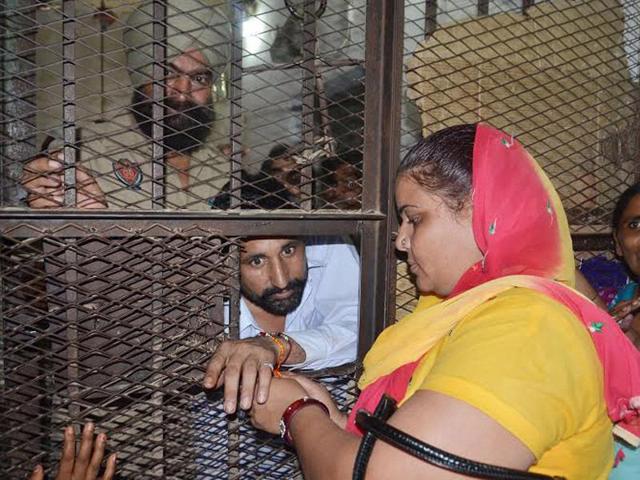 A woman tying rakhi to her brother at the Central Jail in Amritsar on Saturday. Sameer Sehgal/HT
