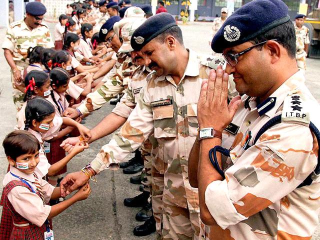 Young girls tie rakhis on wrists of Indo-Tibetan Border Police (ITBP) officers and jawans on the occasion of Raksha Bandhan in Jalandhar. (PTI Photo) Young girls tie rakhis on wrists of Indo-Tibetan Border Police (ITBP) officers and jawans on the occasion of Raksha Bandhan in Jalandhar. (PTI Photo)