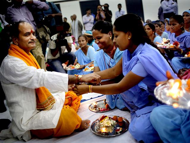 Indian scavenger women, earlier considered untouchables, tie Rakhi on the wrist of a Hindu holy man during an event organized by a non-governmental organisation Sulabh International.(AP Photo/ Altaf Qadri) Indian scavenger women, earlier considered untouchables, tie Rakhi on the wrist of a Hindu holy man during an event organized by a non-governmental organisation Sulabh International.(AP Photo/ Altaf Qadri)