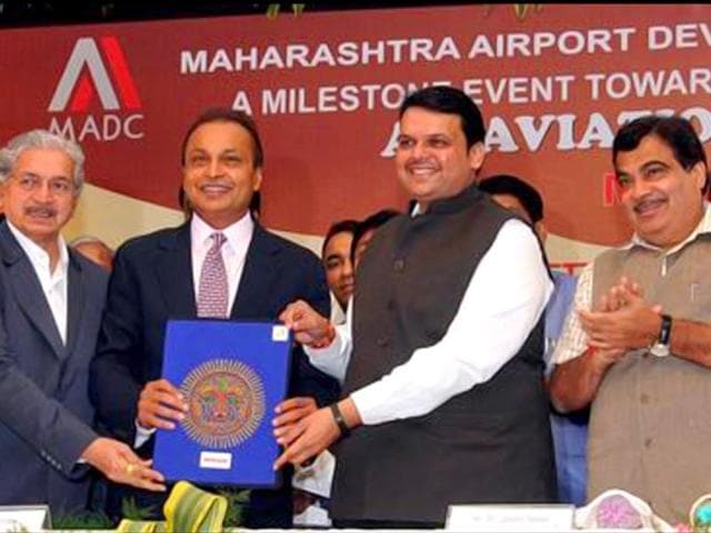 Maharashtra CM Devendra Fadnavis handing over the allotment letter of 289 acres of land in Nagpur's Mihan SEZ for Dhirubhai Ambani Aerospace Park (DAAP) to the chairman of Reliance Group, Anil Ambani. (Photo source: Twitter/Dev_Fadnavis)