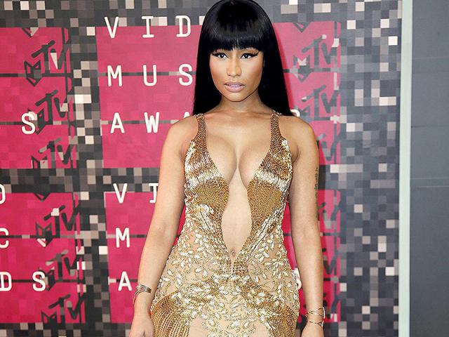 Nicki Minaj channels goddess chic in this gold gown embellished with beads and sequins. The Anaconda hitmaker called out Miley in a (fake?) fight during VMAs which was all the news. (AFP photo)