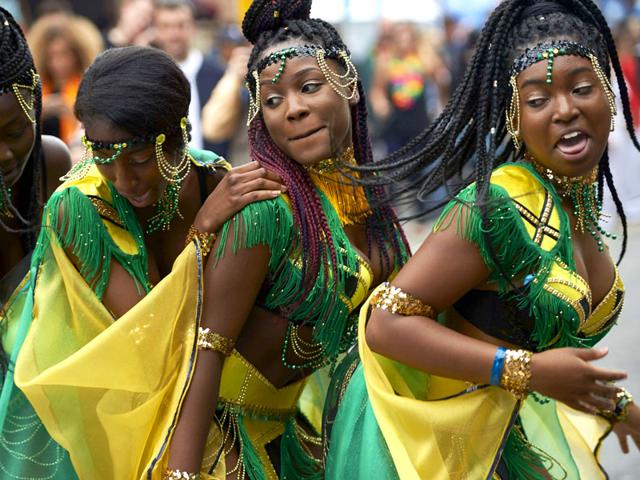 Performers dance on the first day of the Notting Hill Carnival in London on August 30, 2015. (AFP)
