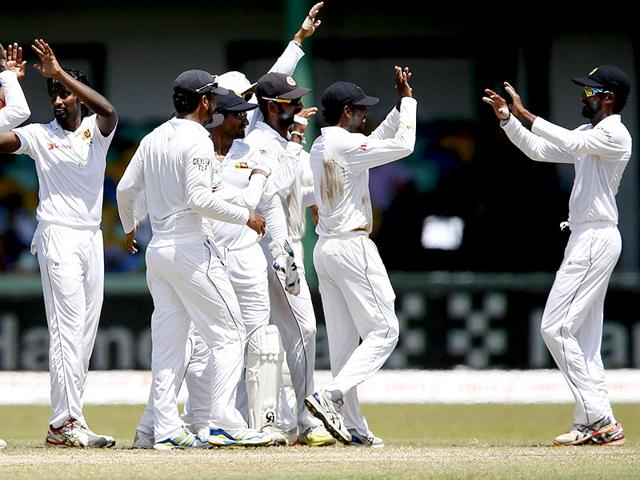 Sri Lanka's Nuwan Pradeep, second from left, celebrates with captain Angelo Mathews, left, and teammates after taking the wicket of Kohli. (Reuters Photo)