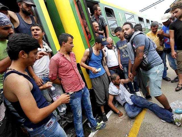 Hungarian policemen stand by the family of migrants as they wanted to run away at the railway station in the town of Bicske, Hungary. (Reuters) Hungarian policemen stand by the family of migrants as they wanted to run away at the railway station in the town of Bicske, Hungary. (Reuters)