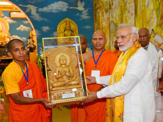 Prime Minister Narendra Modi being presented a memento by monks at a temple in Bodh Gaya on Saturday. (PTI Photo) Prime Minister Narendra Modi being presented a memento by monks at a temple in Bodh Gaya on Saturday. (PTI Photo)
