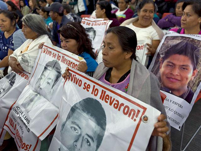 In this March 26, 2015 file photo drawings of some of 43 missing students are surrounded by flower petals, formimg the shape of a heart, during a protest marking the six-month anniversary of their disappearance, in Mexico City (AP Photo) In this March 26, 2015 file photo drawings of some of 43 missing students are surrounded by flower petals, formimg the shape of a heart, during a protest marking the six-month anniversary of their disappearance, in Mexico City (AP Photo)